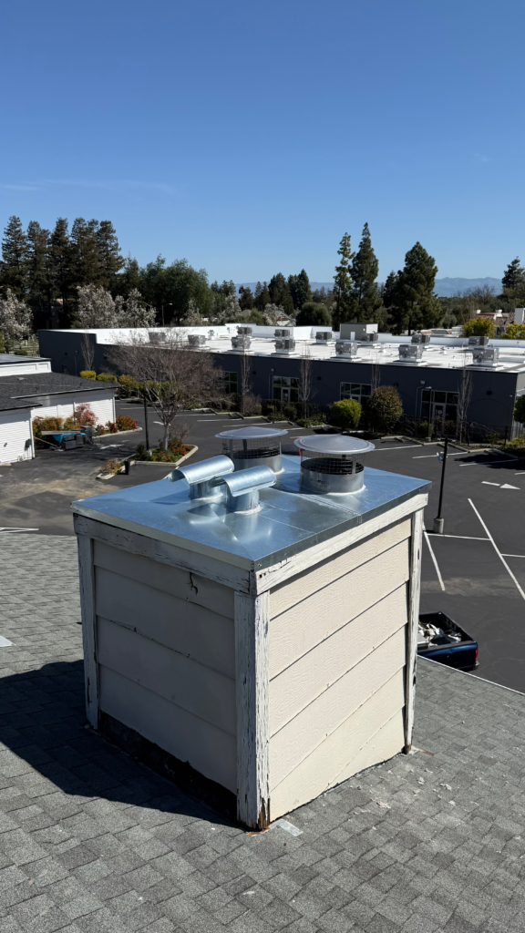 wooden chimney with silver chimney cap on rooftop in the bay area, california