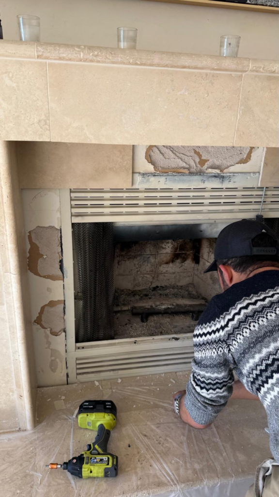 Technician installing metal framed fireplace doors in San Francisco Bay Area home