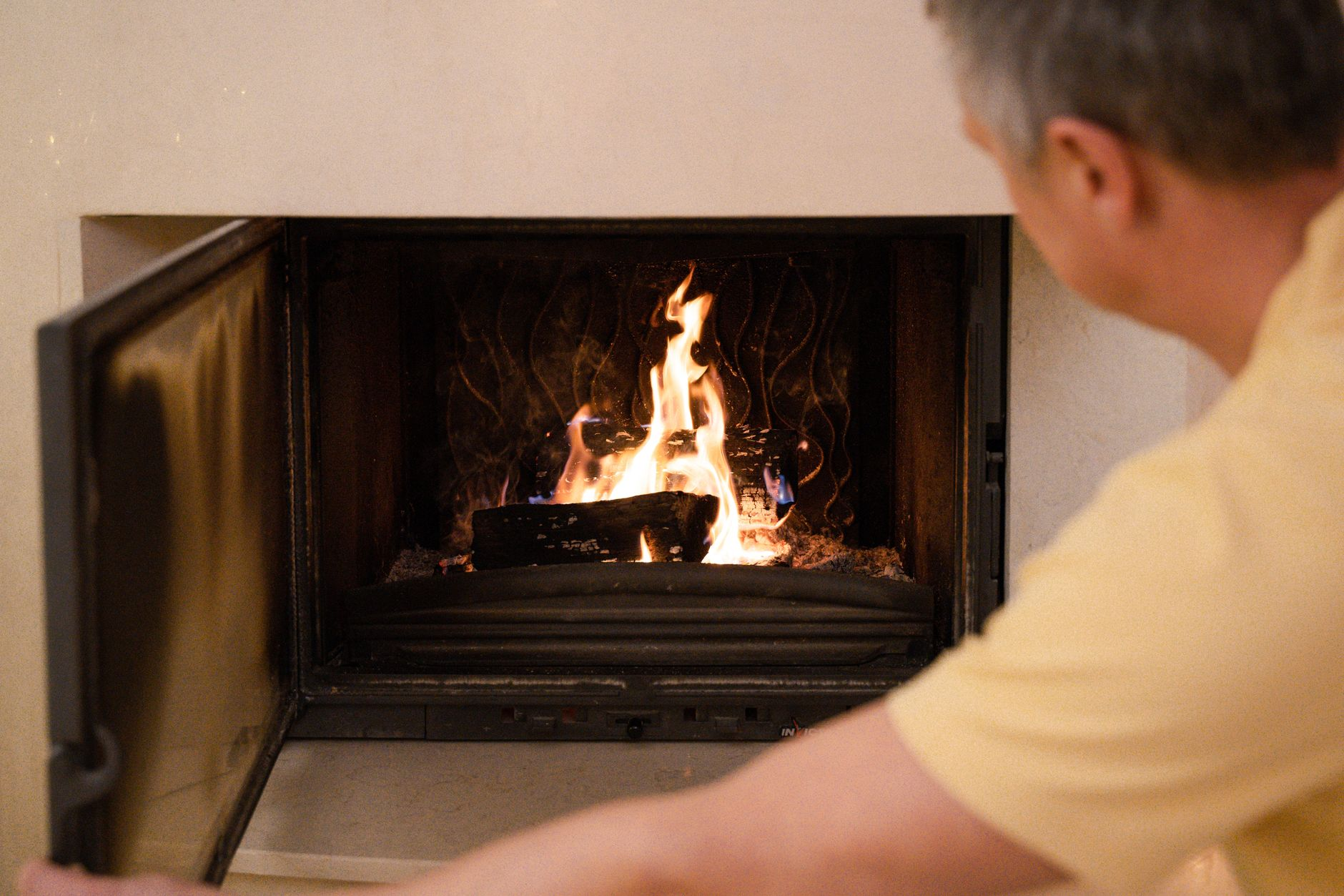 Technician checking a gas fireplace flame during a gas fireplace service call in the San Francisco Bay Area