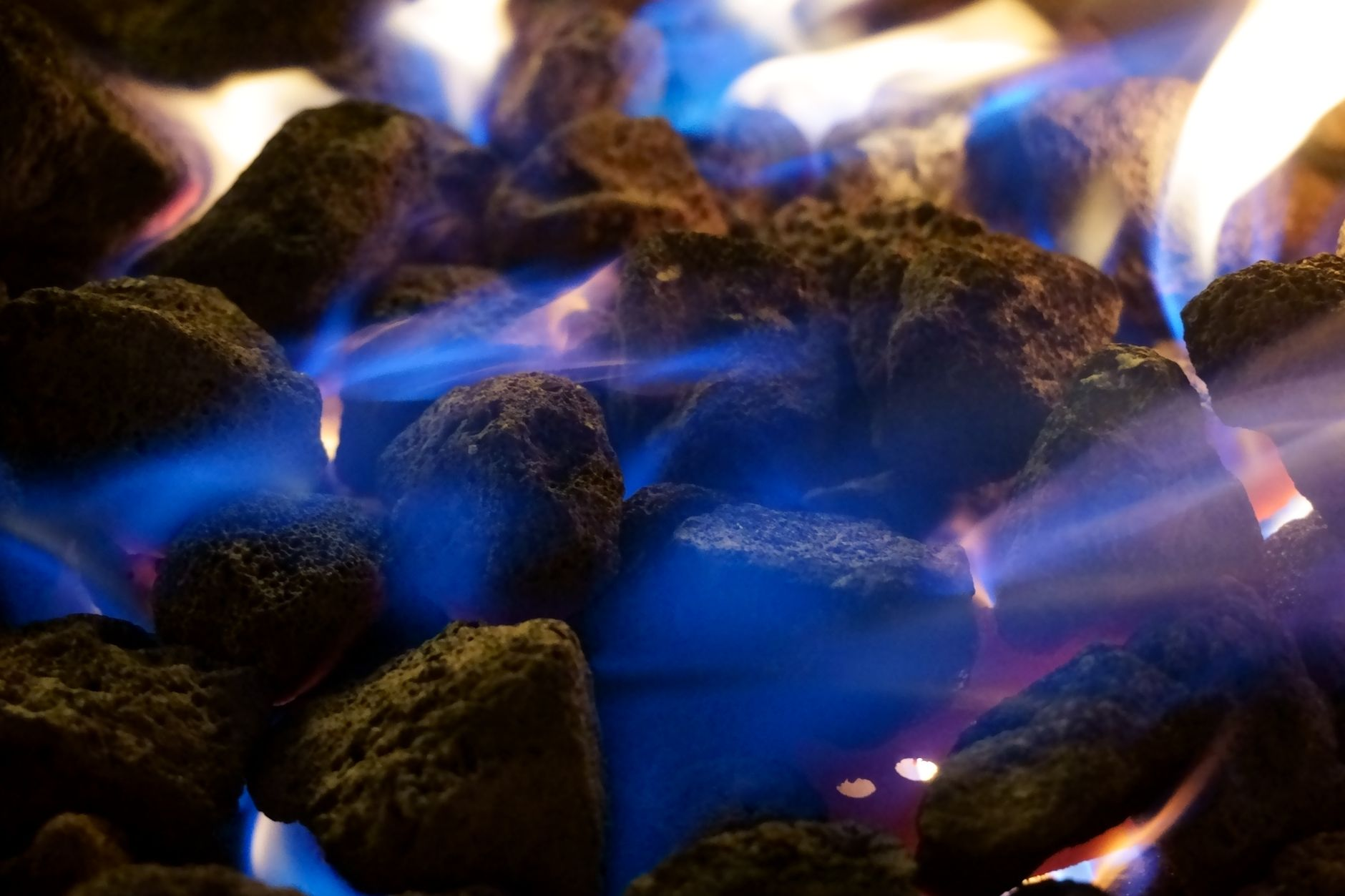 Blue flames on burning charcoal during fireplace conversion in the Bay Area including Oakland and San Francisco