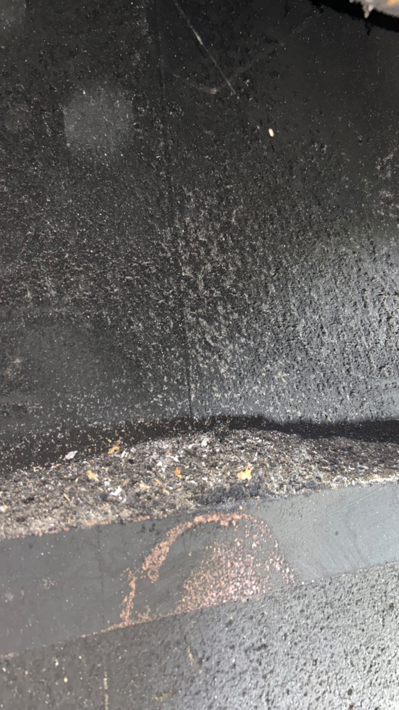 Soot and creosote buildup on flue wall before chimney sweep in the San Francisco Bay Area