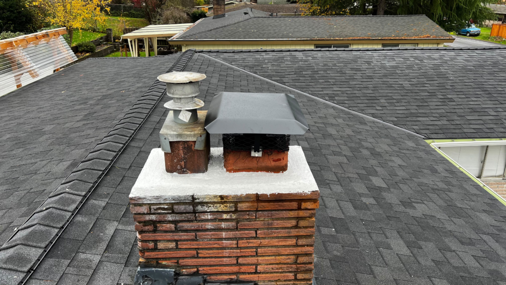 Finished white chimney crown on brick chimney with two flues after chimney crown repair in the San Francisco Bay Area